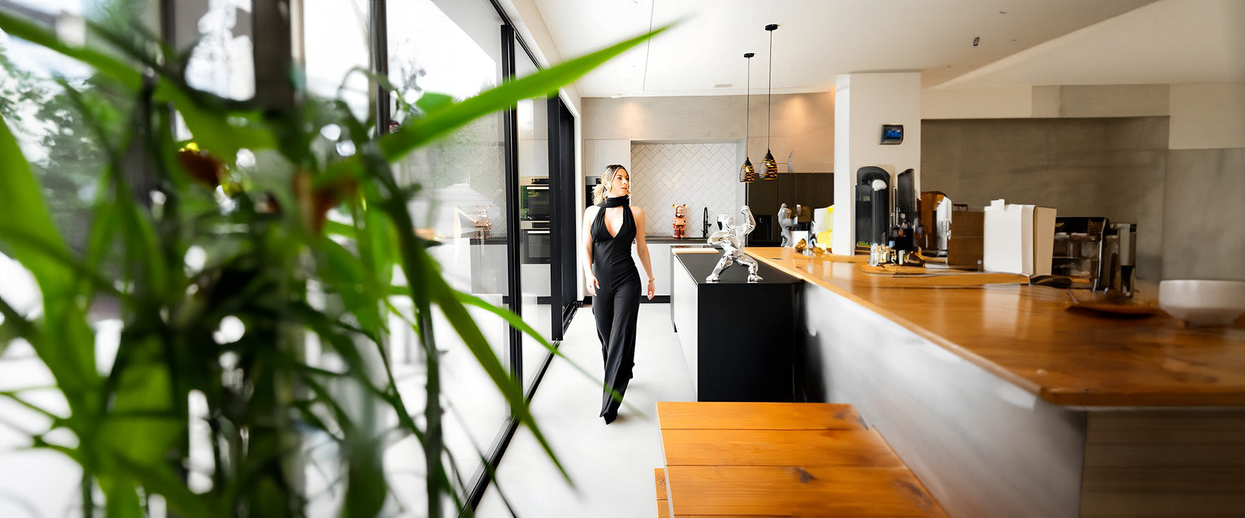 a woman walking in a stylish home next to a giant bears sculpture 