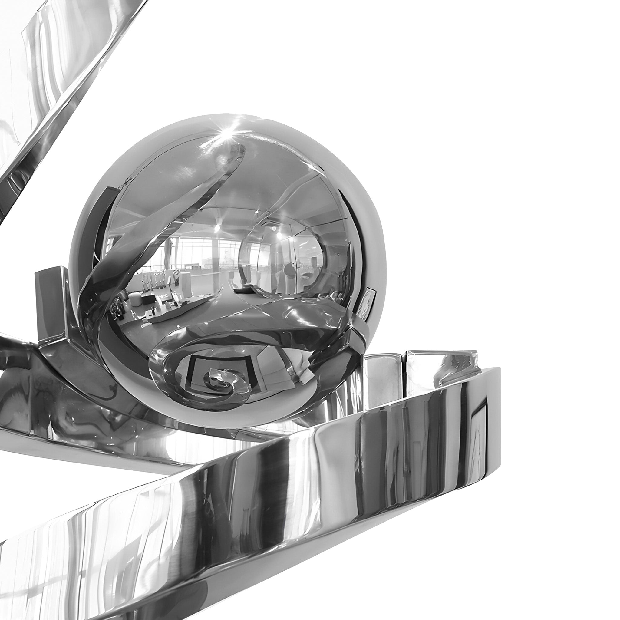 Close-up of a highly reflective chrome ball sculpture, showcasing smooth curves and mirrored surfaces, adding a modern touch to any interior space.