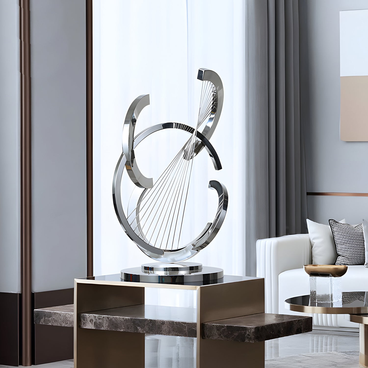 The sleek stainless steel sculpture stands elegantly on a pedestal, adding a contemporary touch to the minimalist living room setting.