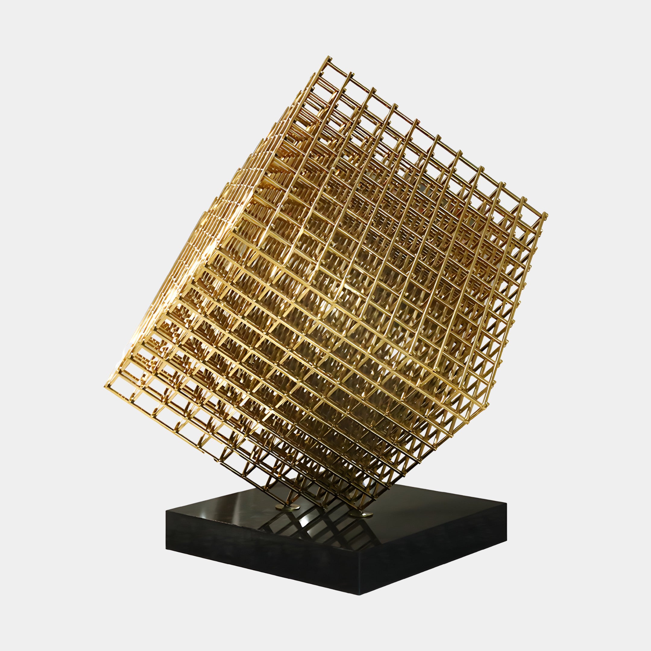 A geometric stainless steel sculpture with a luxurious gold finish, set against a sleek black base. Its open-frame design plays with light and shadow, making it an ideal statement piece for upscale interiors or modern gardens.