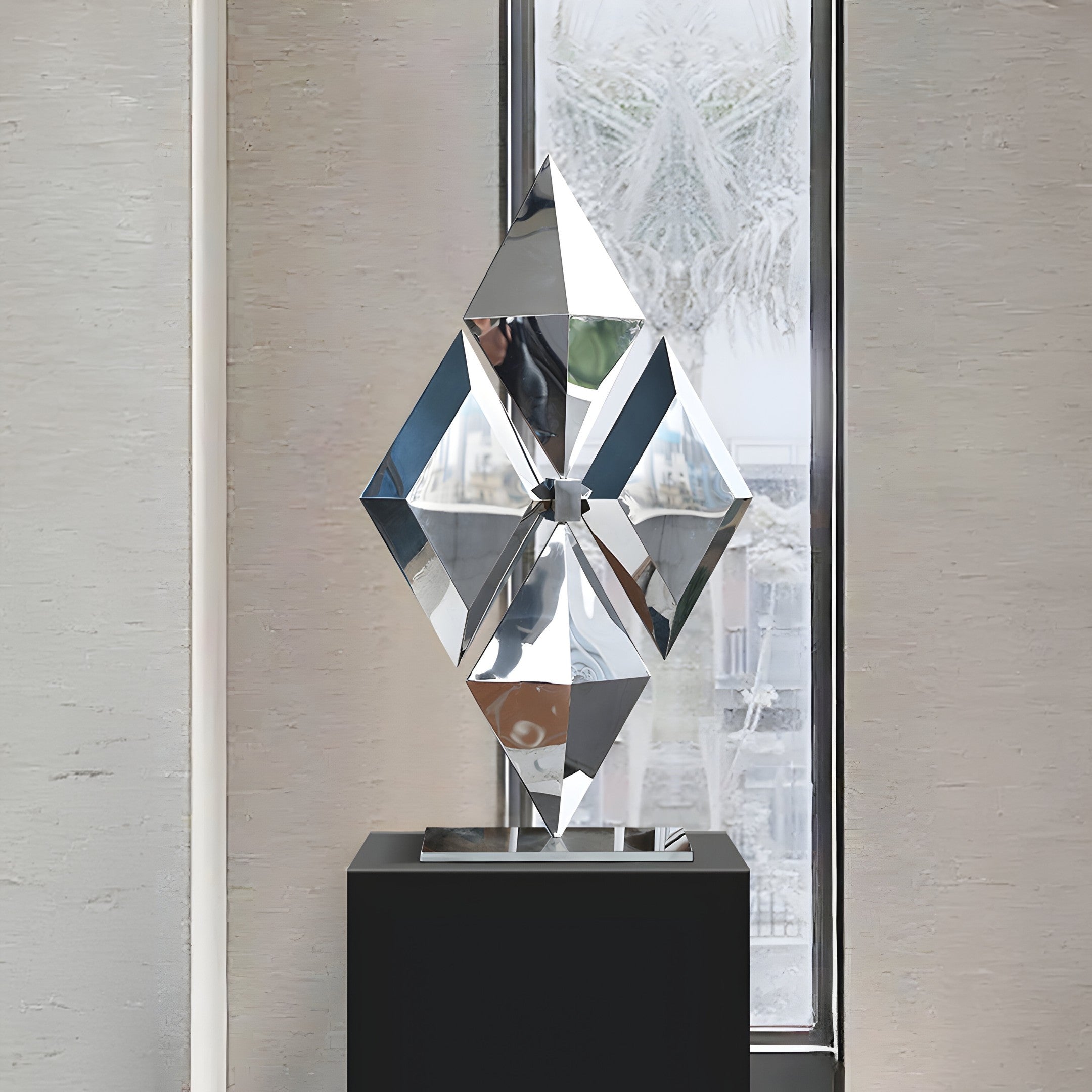 A diamond-shaped geometric sculpture in a modern indoor setting, its reflective surfaces enhancing the elegance of contemporary interiors.