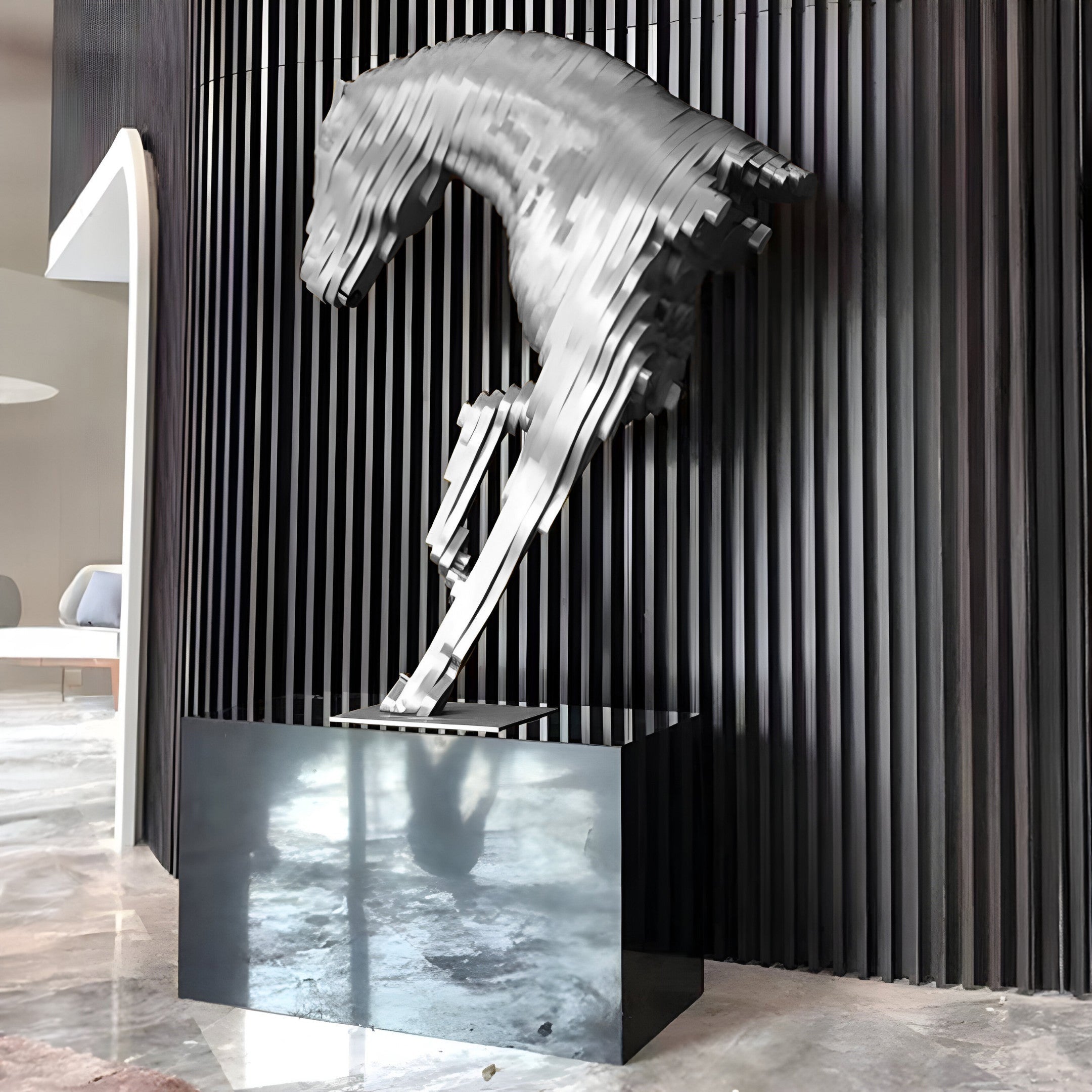 Silver stainless steel horse sculpture displayed in a luxury interior, showcasing modern design and light-reflecting surface. Perfect for upscale home decor.