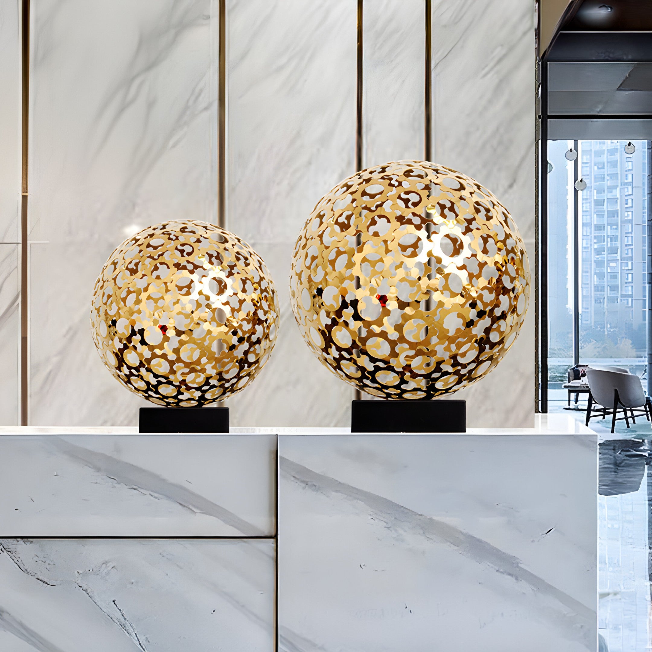 Two Eclipse Gold Sculptures in various sizes, blending seamlessly into a luxury setting, adding a contemporary touch with their circular pattern design.