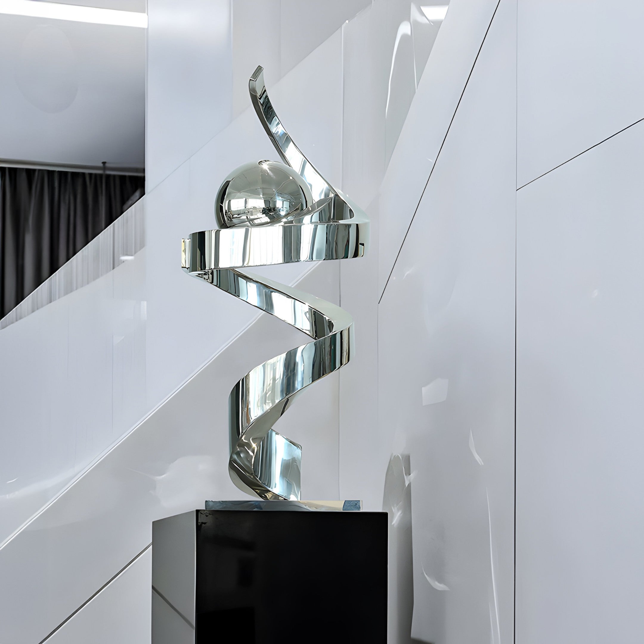 Abstract stainless steel twist sculpture displayed in a modern gallery-like setting, enhancing the space with its sleek, reflective curves.