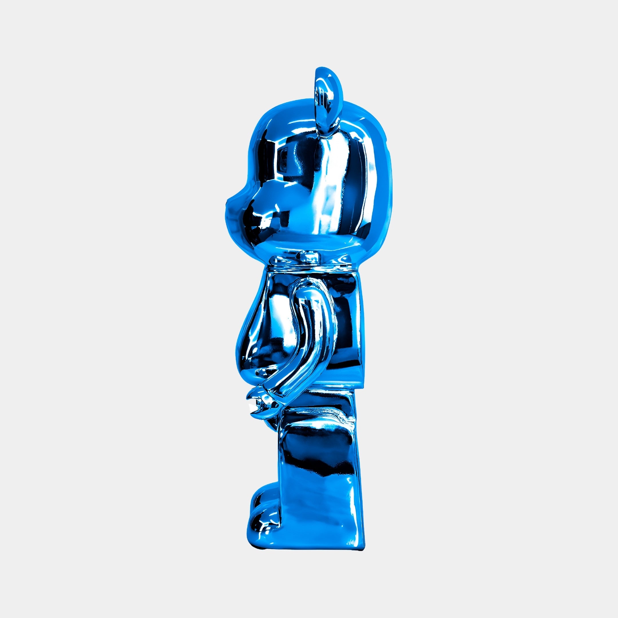 Angled view of Sapphire Blue Bear Sculpture, emphasizing the sleek, reflective surface in a minimalist design.